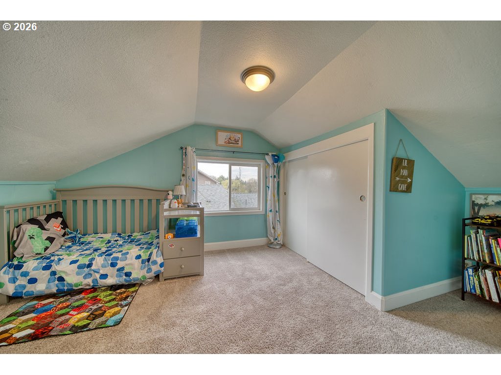 1045 Umatilla Street St. Helens, OR 97051 - Photo 24 of 43 a bedroom with furniture and a wooden floor