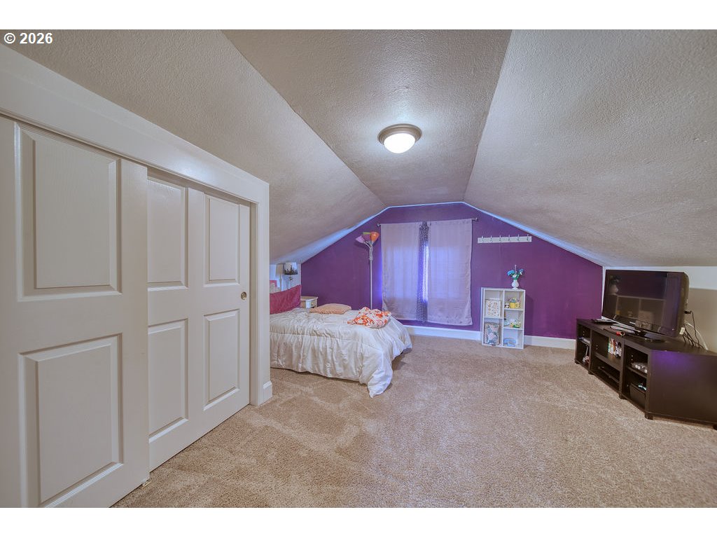1045 Umatilla Street St. Helens, OR 97051 - Photo 26 of 43 a spacious bedroom with a bed and a couch