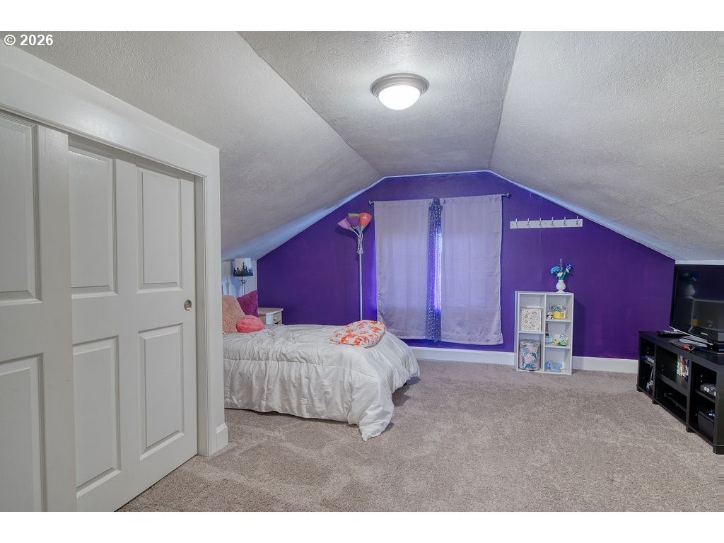 1045 Umatilla Street St. Helens, OR 97051 - Photo 28 of 43 a bed room with a bed and a chair