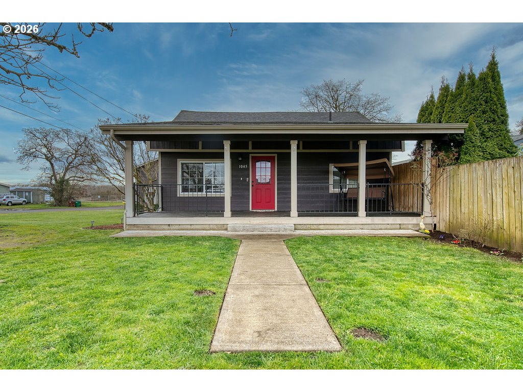 1045 Umatilla Street St. Helens, OR 97051 - Photo 3 of 43 a view of a house with a small yard and wooden floor and fence