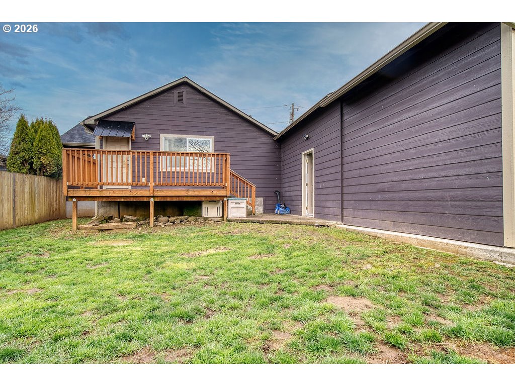 1045 Umatilla Street St. Helens, OR 97051 - Photo 36 of 43 a view of a house with a backyard and wooden deck