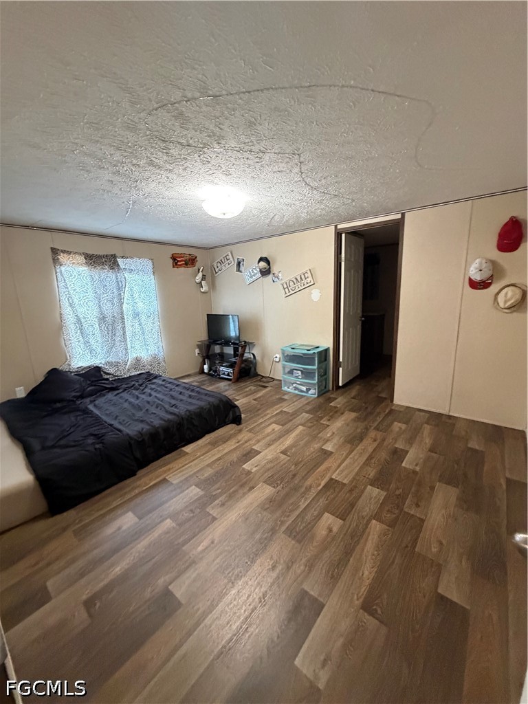 631 Stanton Street Clewiston, FL 33440 - Photo 11 of 24 a large bedroom with a bed and a large window