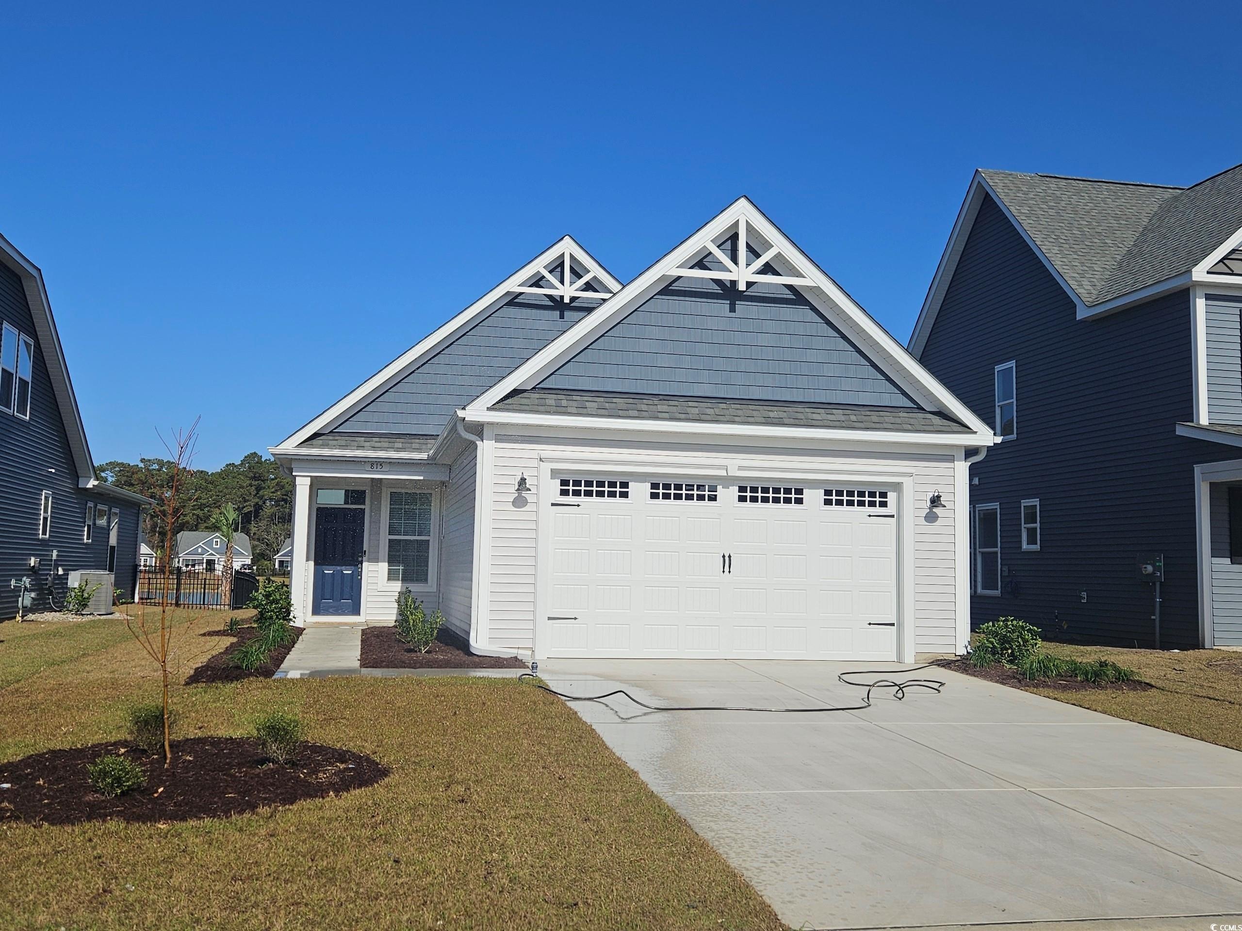 815 Cascade Loop Little River, SC 29566 - Photo 1 of 9 View of front of home with a garage and a front ya
