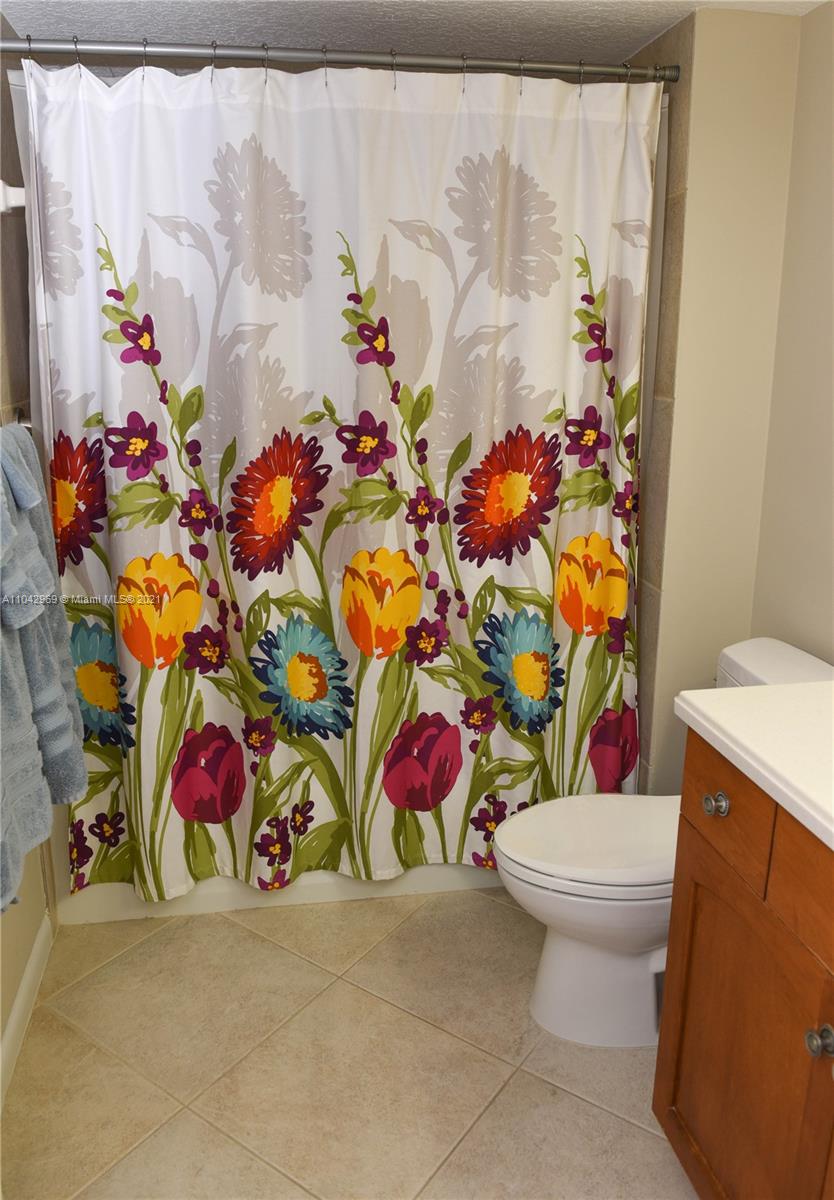20 Northeast Plantation Road, Unit 306 Stuart, FL 34996 - Photo 11 of 20 a bathroom with a toilet sink and mirror