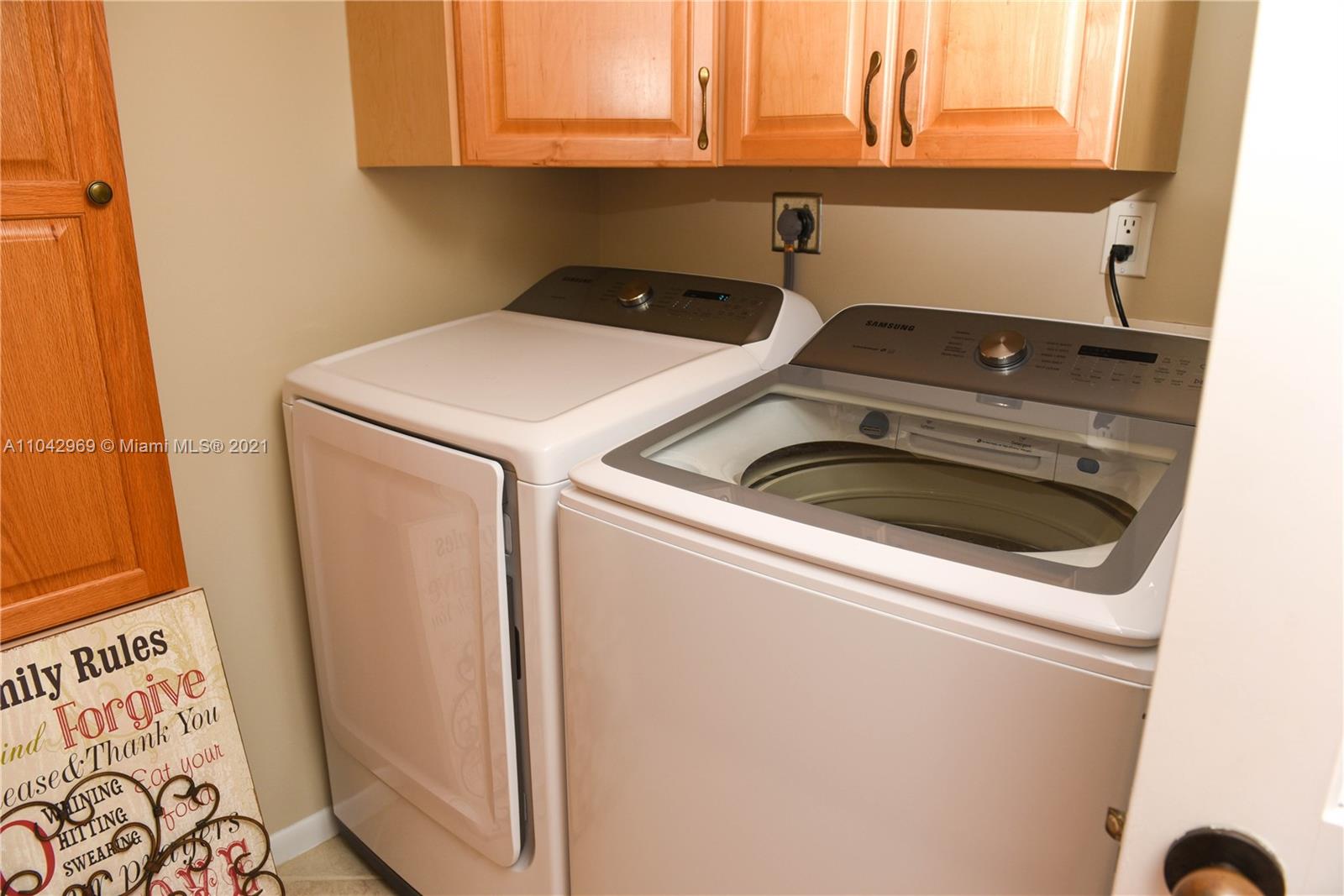 20 Northeast Plantation Road, Unit 306 Stuart, FL 34996 - Photo 12 of 20 a utility room with dryer and washer