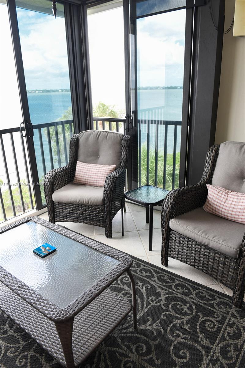 20 Northeast Plantation Road, Unit 306 Stuart, FL 34996 - Photo 15 of 20 a living room with furniture and a window