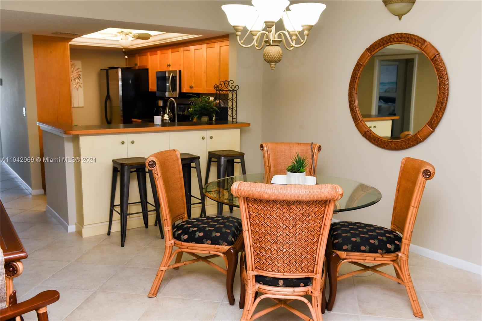 20 Northeast Plantation Road, Unit 306 Stuart, FL 34996 - Photo 5 of 20 a dining room with furniture a chandelier and a rug