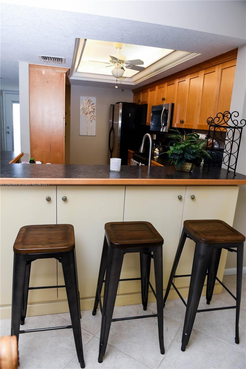 20 Northeast Plantation Road, Unit 306 Stuart, FL 34996 - Photo 6 of 20 a view of two chairs and table in a kitchen