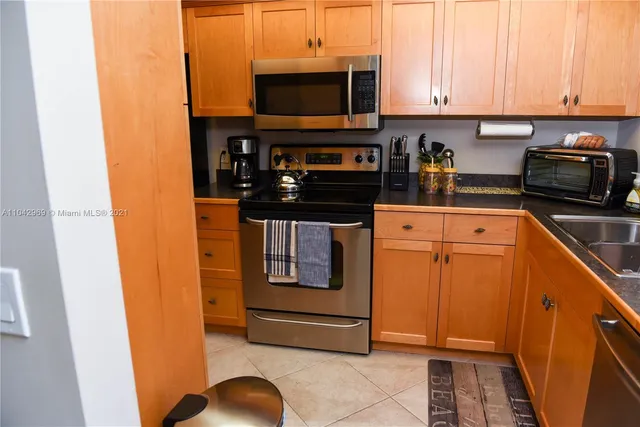 a kitchen with stainless steel appliances granite countertop a stove and a microwave