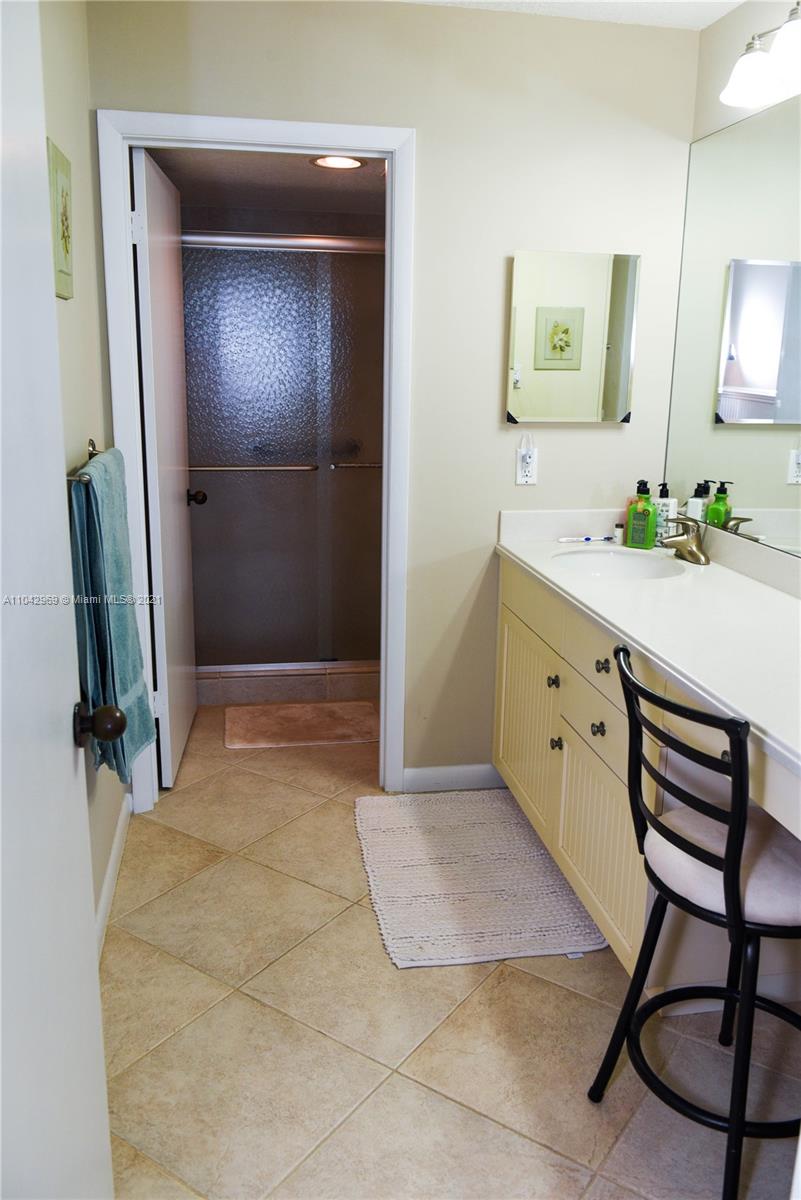 20 Northeast Plantation Road, Unit 306 Stuart, FL 34996 - Photo 9 of 20 a room with a mirror and furniture
