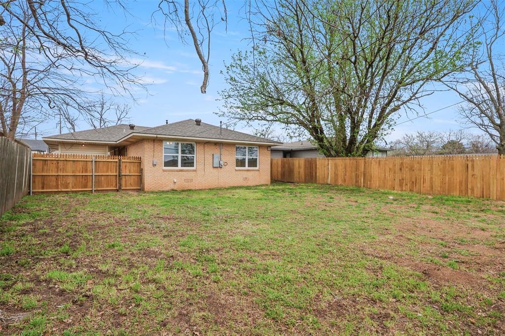 732 Bullock Street Denison, TX 75020 - Photo 23 of 29 a view of a house with a yard