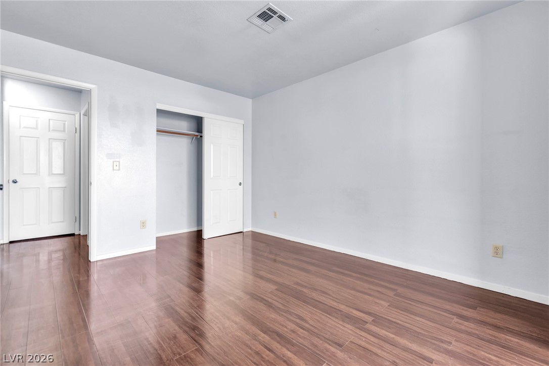 6250 West Flamingo Road, Unit 98 Las Vegas, NV 89103 - Photo 23 of 40 Unfurnished bedroom with baseboards, visible vents, and wood finished floors