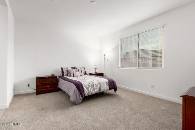 a bed room with a bed and a window