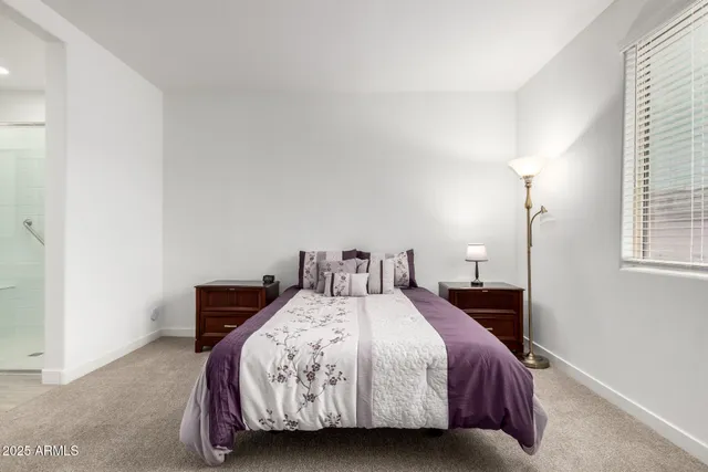 a bedroom with a bed and a night stand