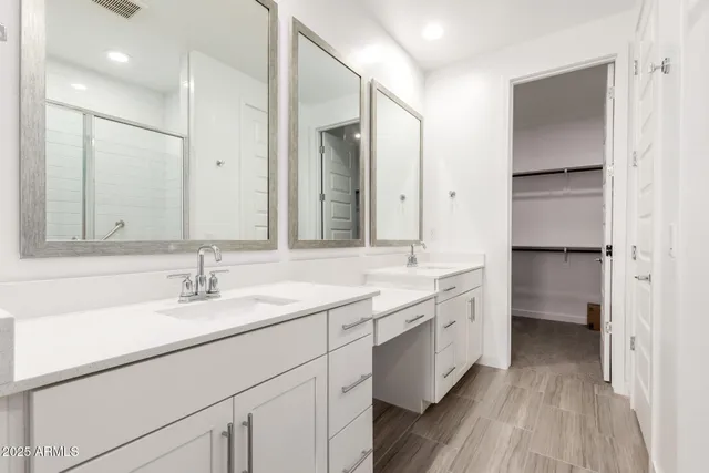 a bathroom with a double vanity sink mirror and