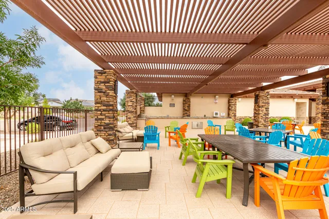 a outdoor patio with swimming pool table and chairs