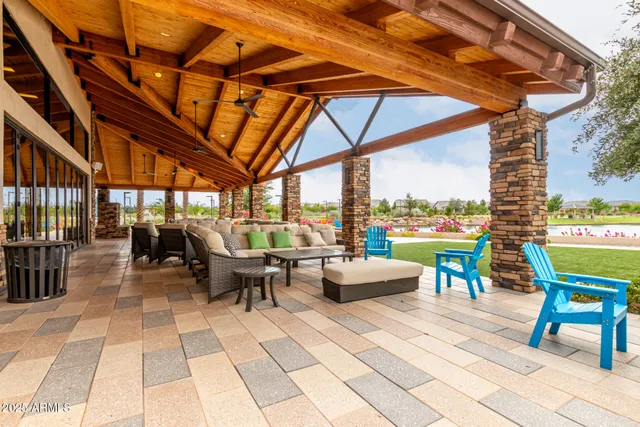 a view of a patio with a dining table and chairs under an umbrella