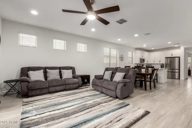 a living room with furniture and a dining table