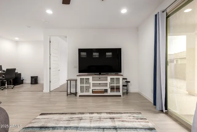 a living room with furniture and flat screen tv
