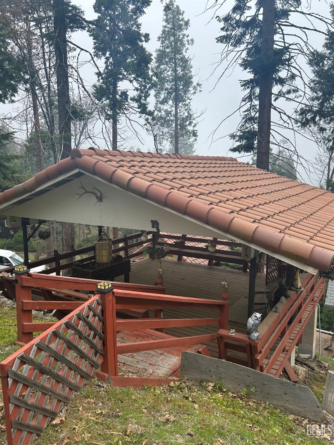 Undisclosed Address Posey, CA 93260 - Photo 19 of 20 a roof deck with table and chairs under an umbrella