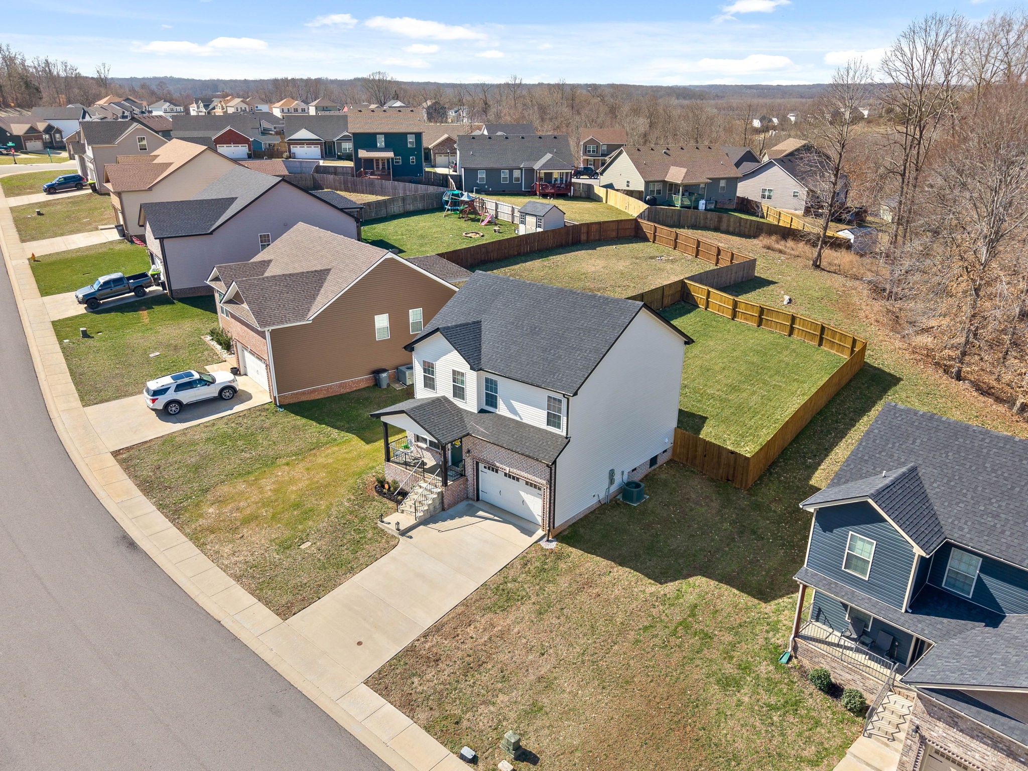 1145 Racker Drive Clarksville, TN 37043 - Photo 3 of 44 an aerial view of a house with a garden and lake view