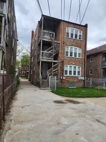 a front view of a building with a yard