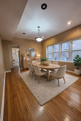 a living room with couches chairs and a large mirror with wooden floor