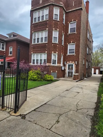 a view of a brick building next to a yard