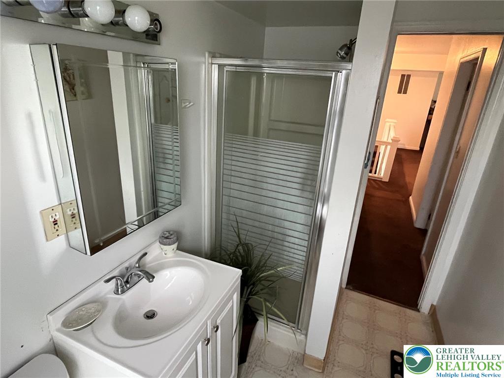765 3rd Street Whitehall, PA 18052 - Photo 25 of 30 A well-maintained bathroom offering a shower stall and vanity with a clean sink.