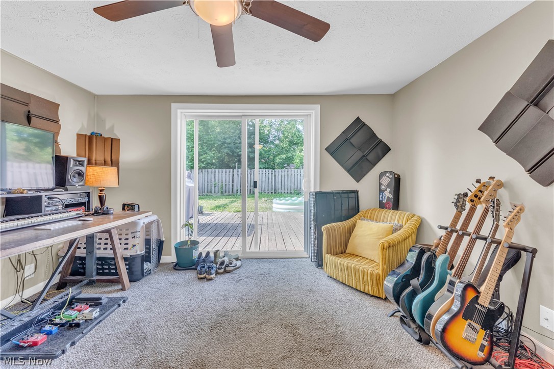 422 West Smith Road Medina, OH 44256 - Photo 12 of 29 Carpeted room featuring a ceiling fan with light, sliding glass doors to the exterior, and neutral wall tones