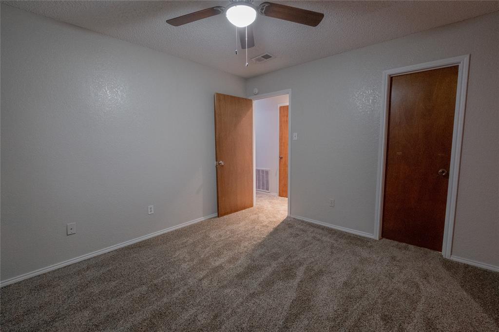 675 Harbor Drive North, Unit C Azle, TX 76020 - Photo 11 of 19 a view of an empty room with a chandelier fan