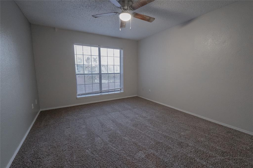675 Harbor Drive North, Unit C Azle, TX 76020 - Photo 13 of 19 an empty room with a ceiling fan and window