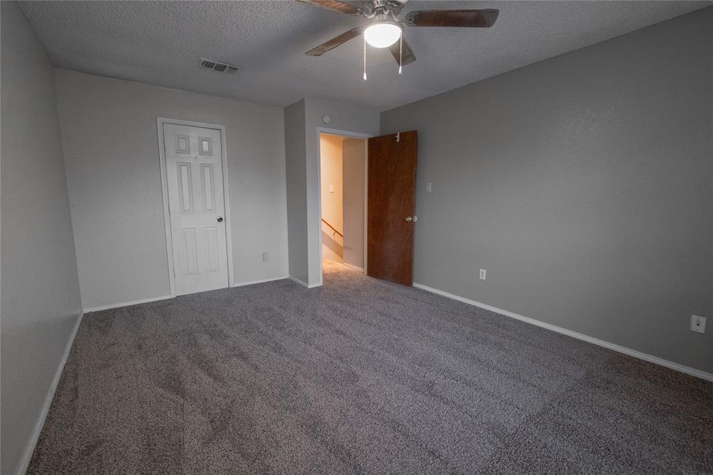 675 Harbor Drive North, Unit C Azle, TX 76020 - Photo 14 of 19 a view of an empty room with a chandelier fan
