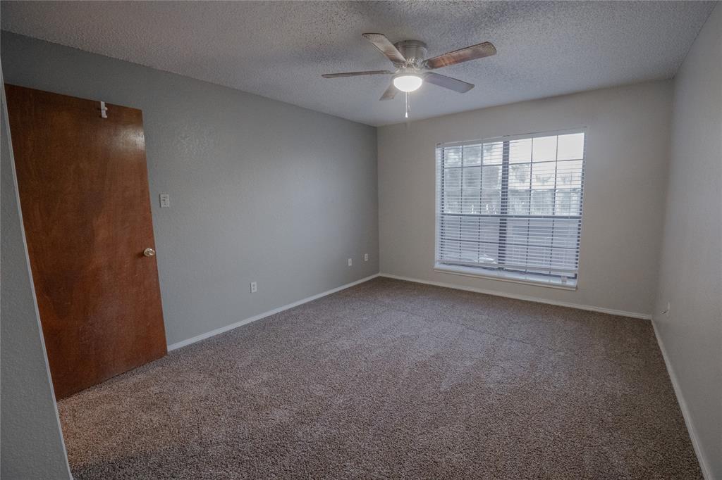 675 Harbor Drive North, Unit C Azle, TX 76020 - Photo 17 of 19 an empty room with windows and fan