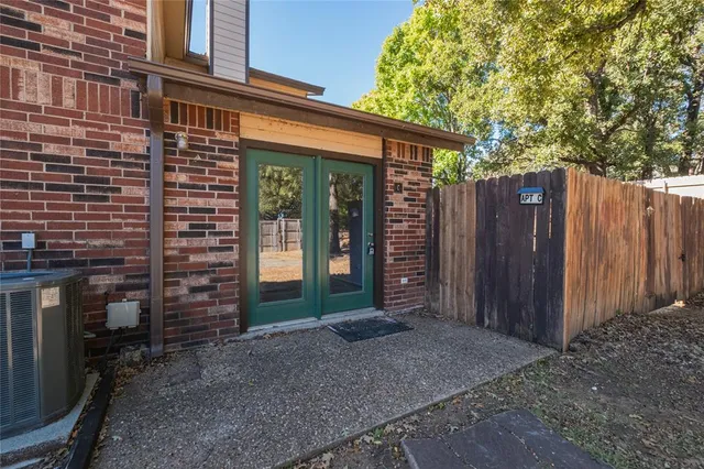 a backyard of a house with barbeque oven
