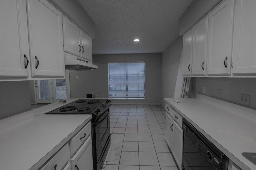 675 Harbor Drive North, Unit C Azle, TX 76020 - Photo 6 of 19 a kitchen with a sink stove and cabinets