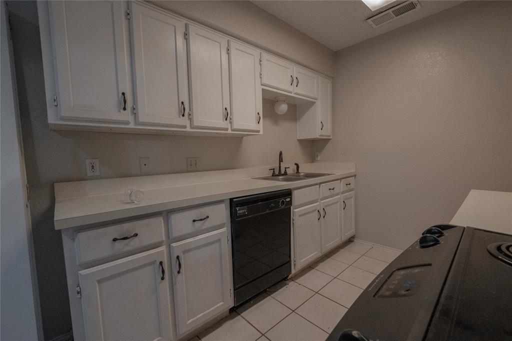 675 Harbor Drive North, Unit C Azle, TX 76020 - Photo 8 of 19 a kitchen with white cabinets and white appliances