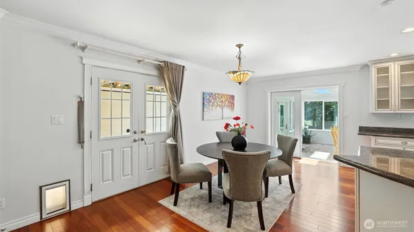 a view of a dining room with furniture window and wooden floor