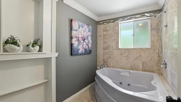 a bathroom with a bathtub and a window