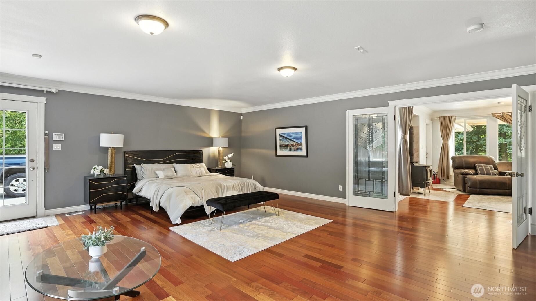 18911 Southeast 144th Street Renton, WA 98059 - Photo 22 of 39 a bedroom with a large bed and a wooden floor