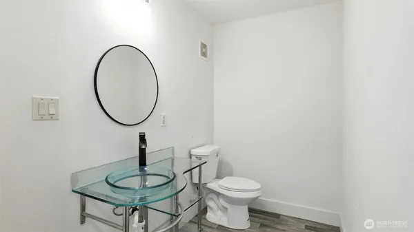 a bathroom with a toilet a sink and a mirror
