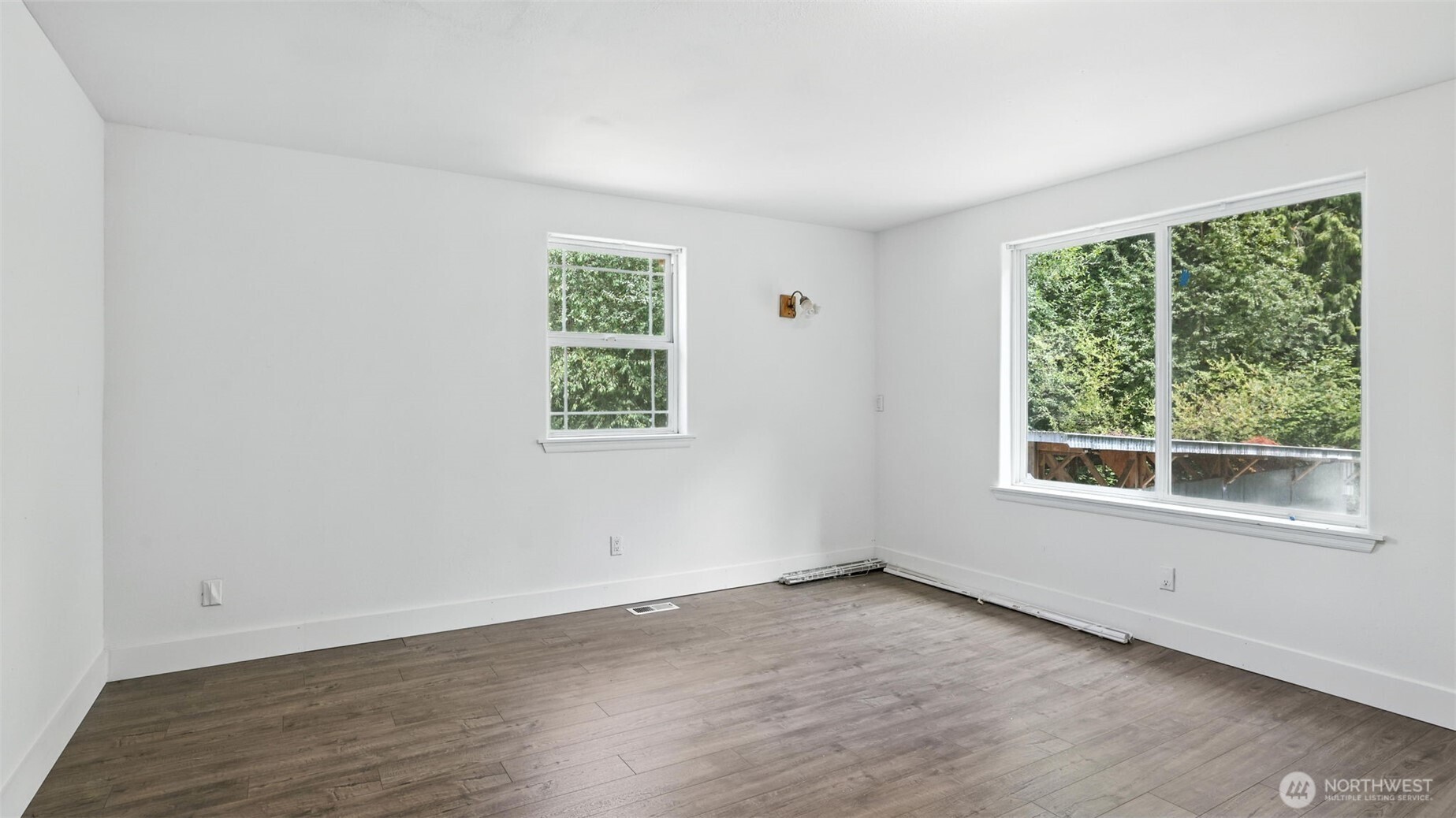 18911 Southeast 144th Street Renton, WA 98059 - Photo 33 of 39 an empty room with wooden floor and windows