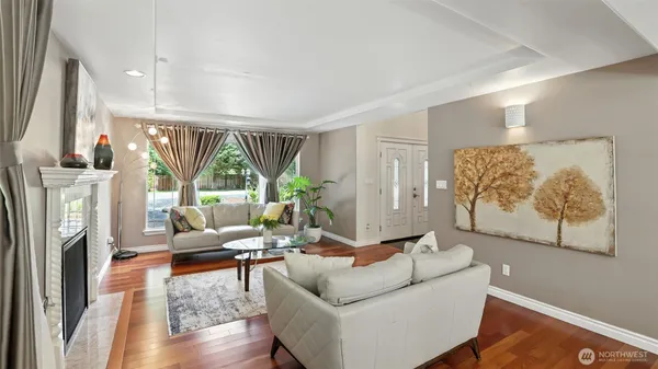 a living room with furniture a fireplace and a flat screen tv