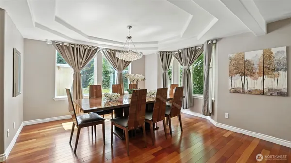 a view of a dining room with furniture window and wooden floor