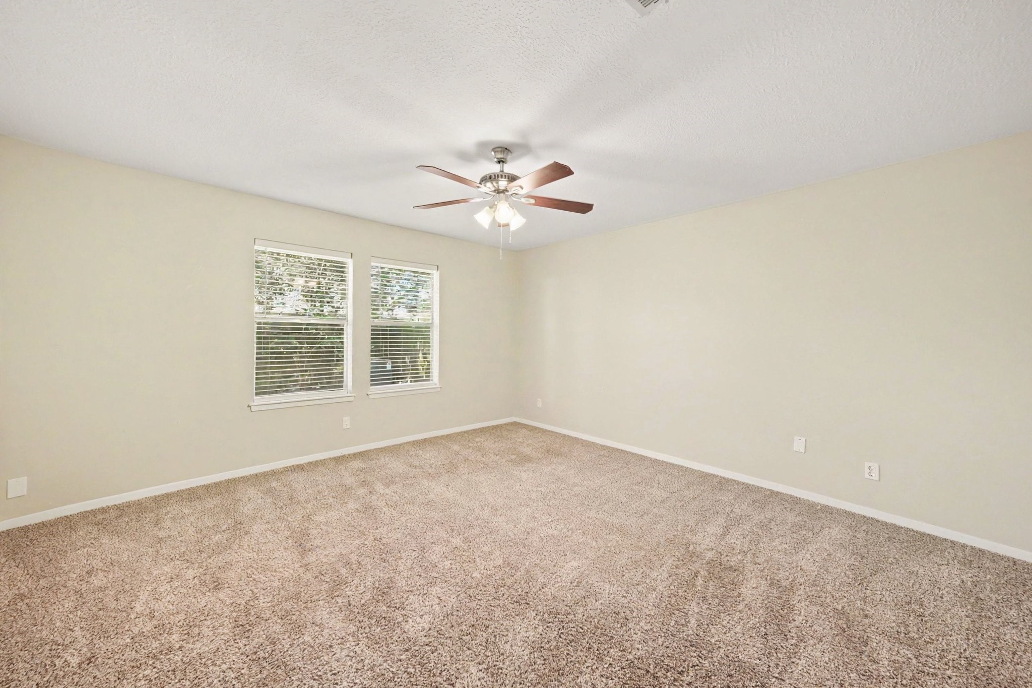 17419 Cassina Drive Spring, TX 77388 - Photo 27 of 35 an empty room with windows and chandelier fan