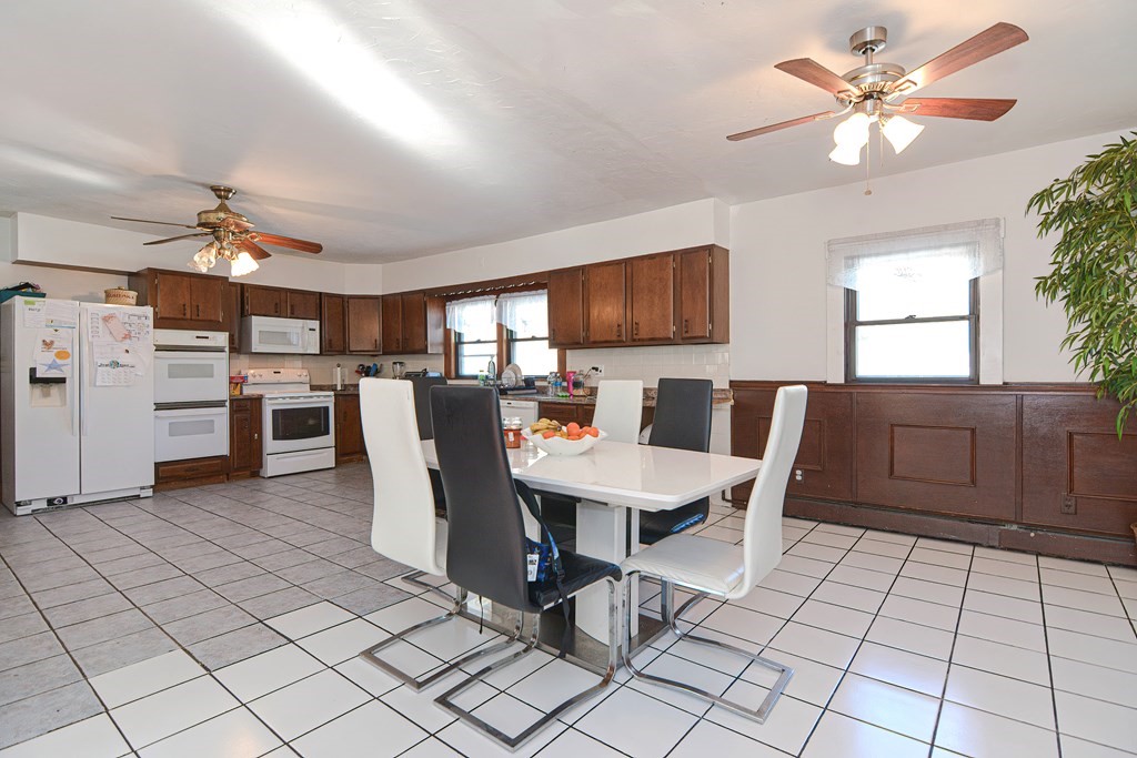 110 Danforth Street Framingham, MA 01701 - Photo 16 of 28 a living room with furniture a flat screen tv and kitchen view