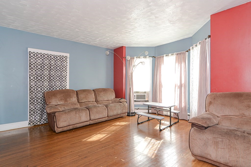 110 Danforth Street Framingham, MA 01701 - Photo 18 of 28 a living room with furniture and a large window