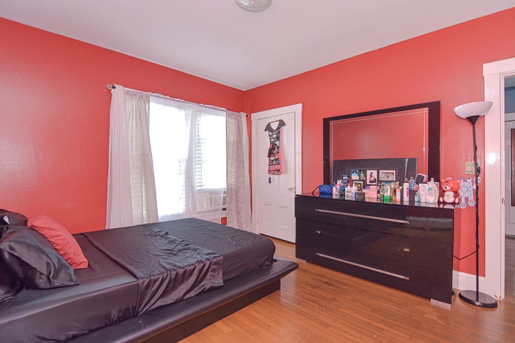 110 Danforth Street Framingham, MA 01701 - Photo 19 of 28 a bedroom with a bed and a mirror on dresser