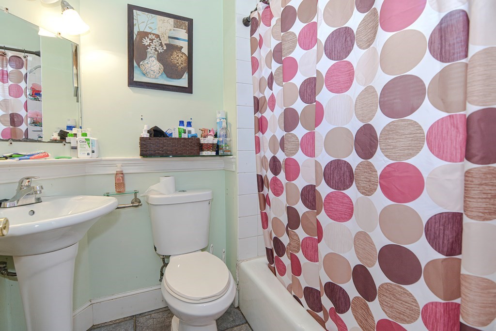 110 Danforth Street Framingham, MA 01701 - Photo 28 of 28 a bathroom with a sink and mirror with toilet