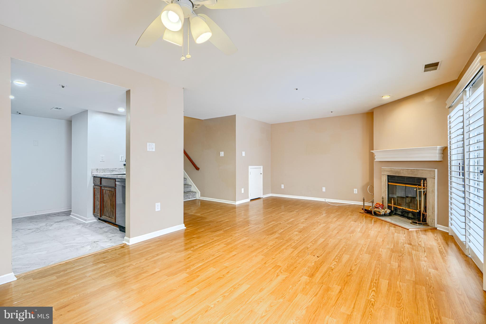 14235 Jib Street, Unit 7342 Laurel, MD 20707 - Photo 14 of 25 a view of empty room with a fireplace and wooden floor